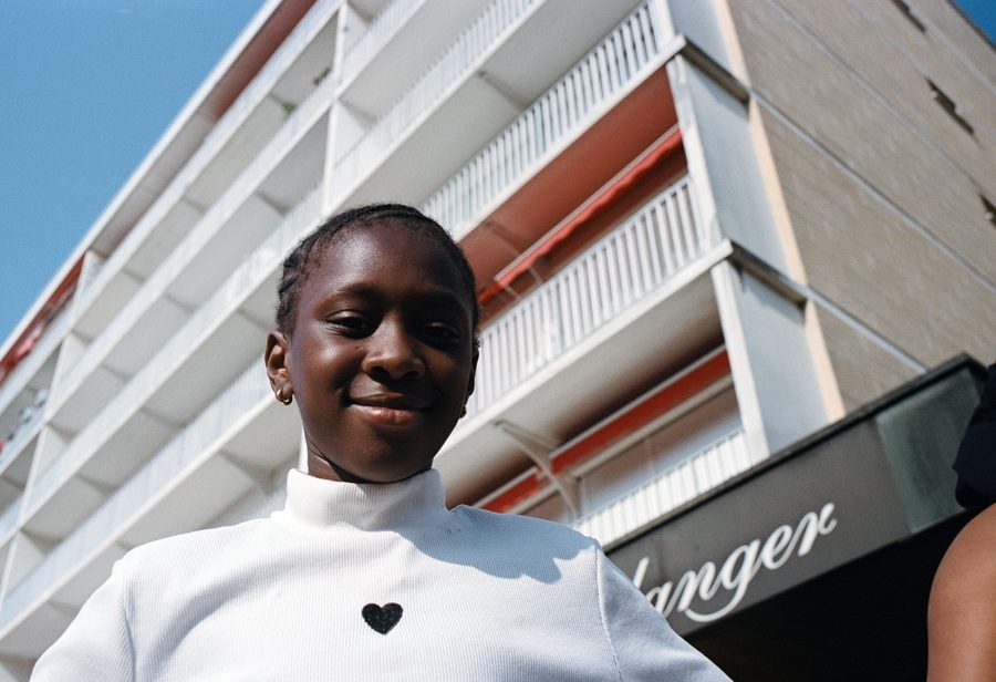une jeune fille en t-shirt blanc devant la boulangerie