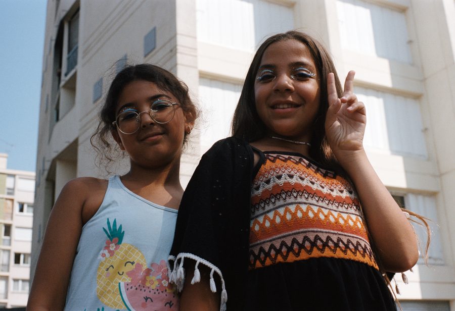 deux amies posent devant les tours, l’une fait le signe de la paix